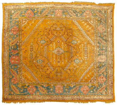 Appraisal: Oushak rug geometric designs on amber field salmon and blue