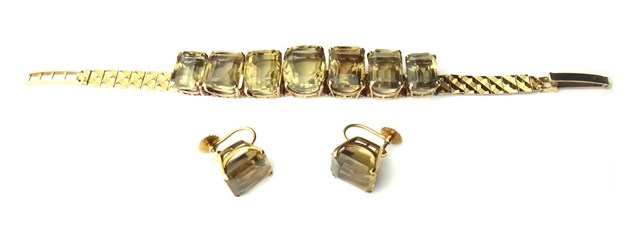 Appraisal: A gold and smoky quartz set seven stone bracelet in