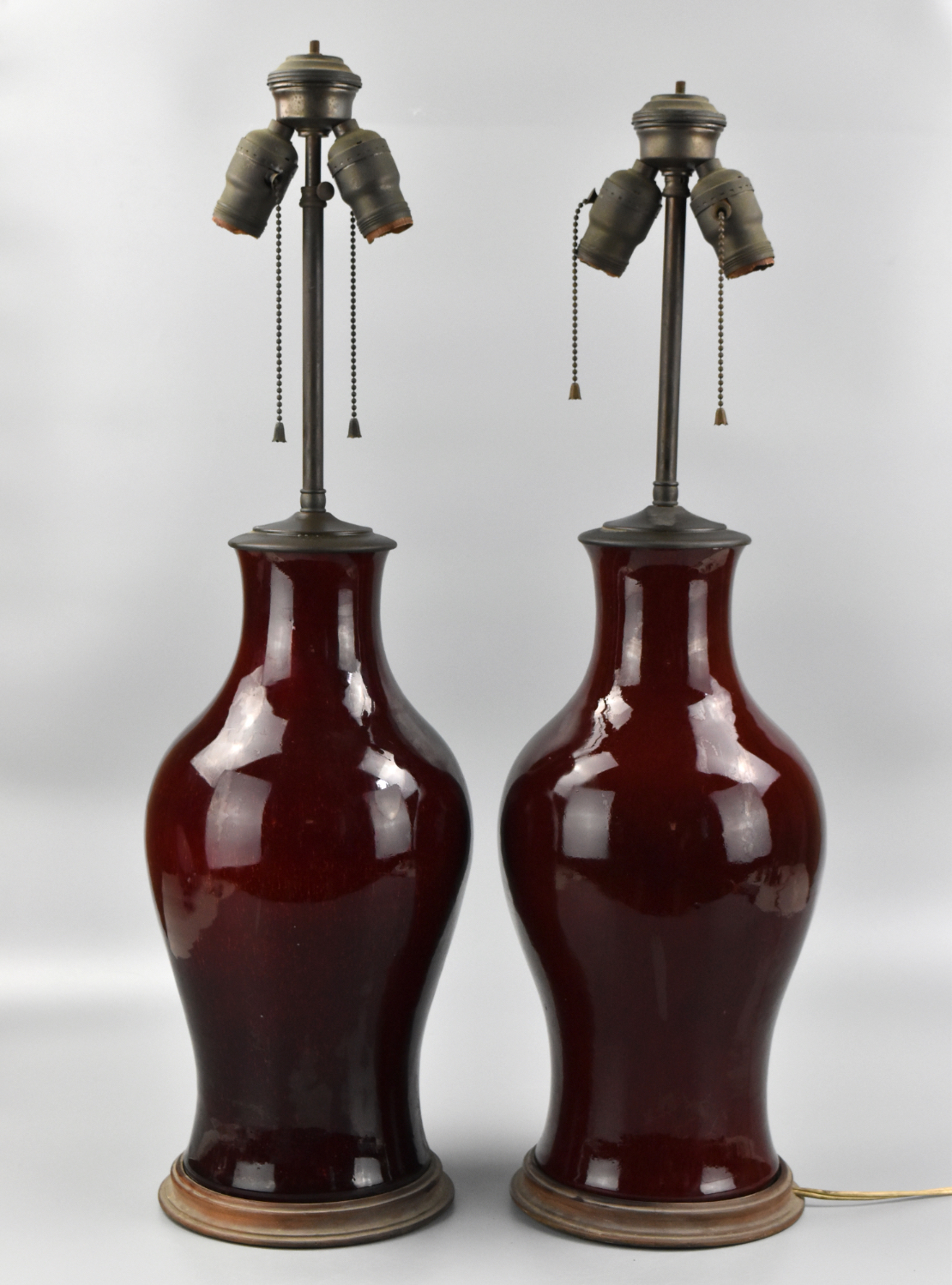 Appraisal: A pair of Chinese dark red flambe glazed vases converted