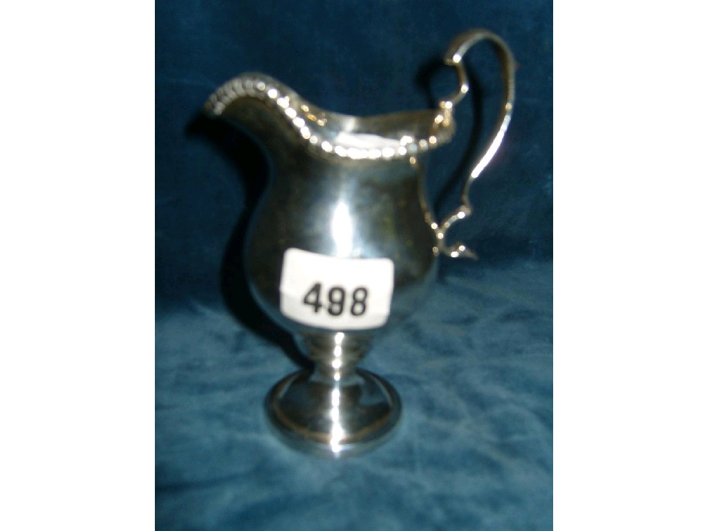 Appraisal: A Georgian style silver milk jug of baluster form on