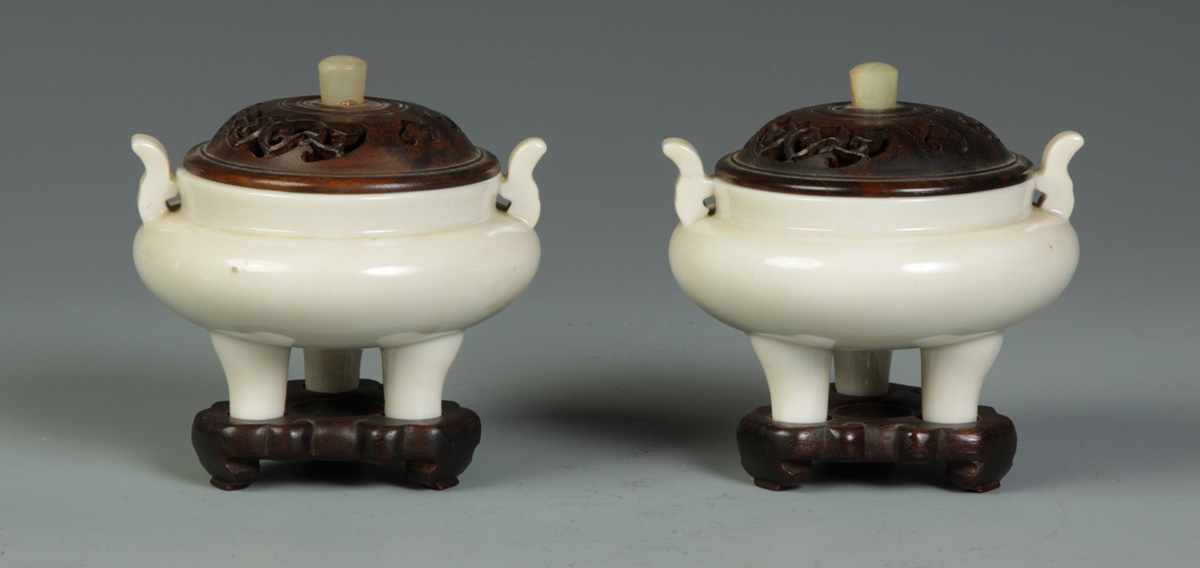 Appraisal: Pair of Censors Carved teakwood tops bases Repair to handle