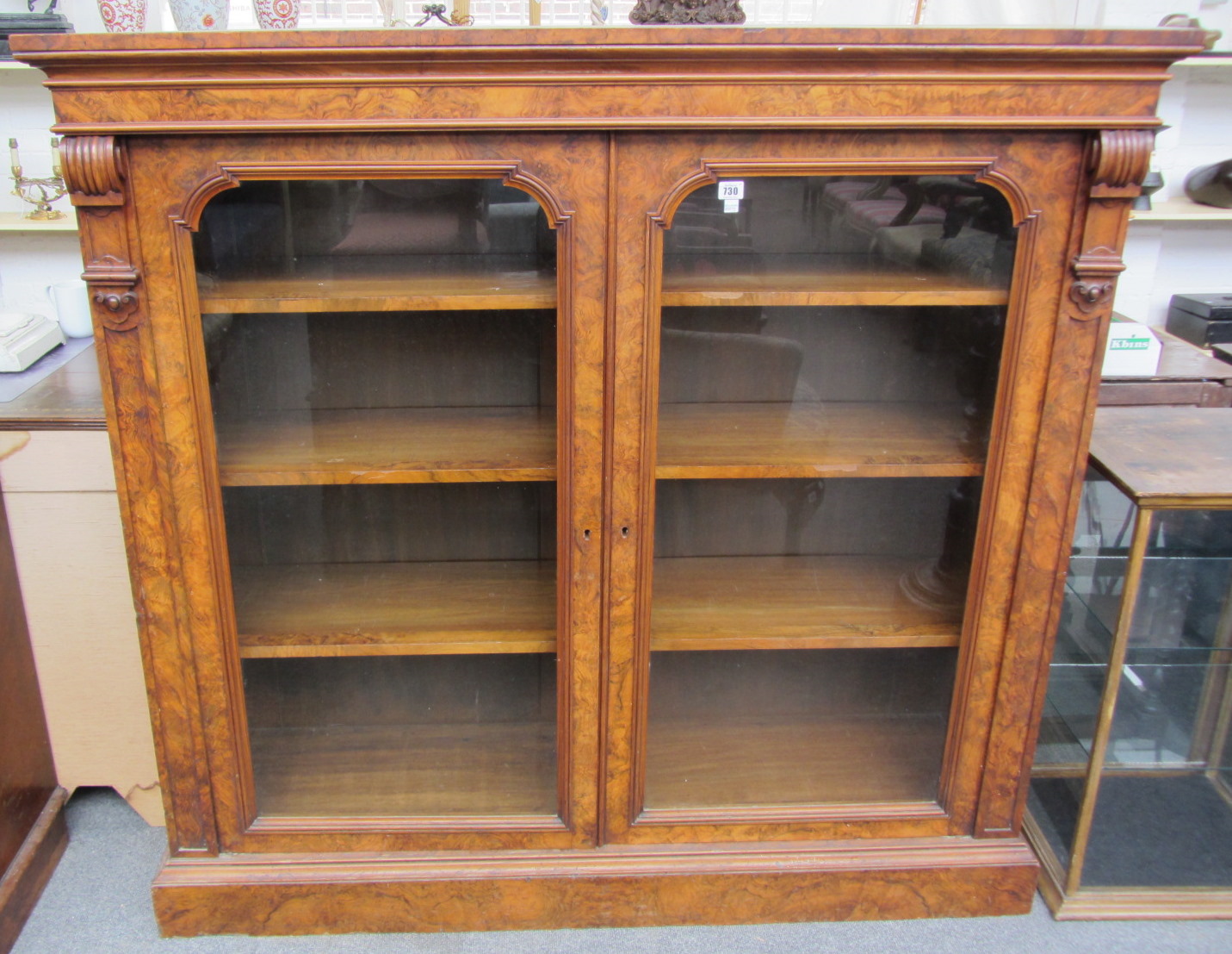 Appraisal: A Victorian figured walnut floor standing glazed two door bookcase