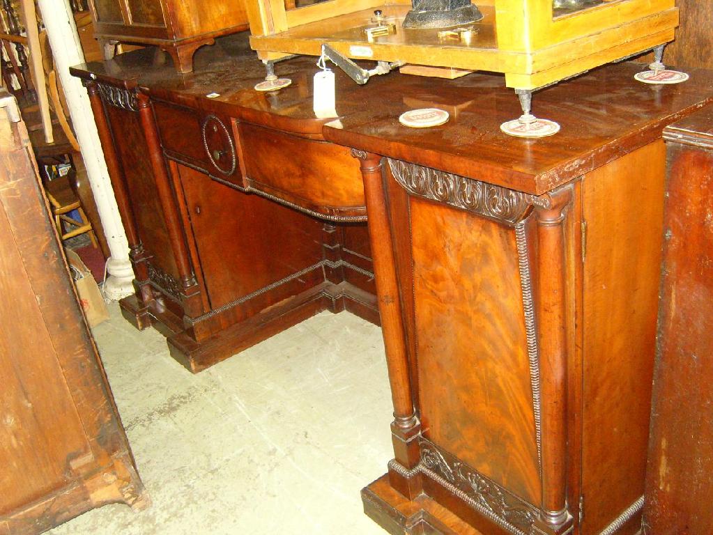 Appraisal: A Regency mahogany sideboard with shaped front fitted with a