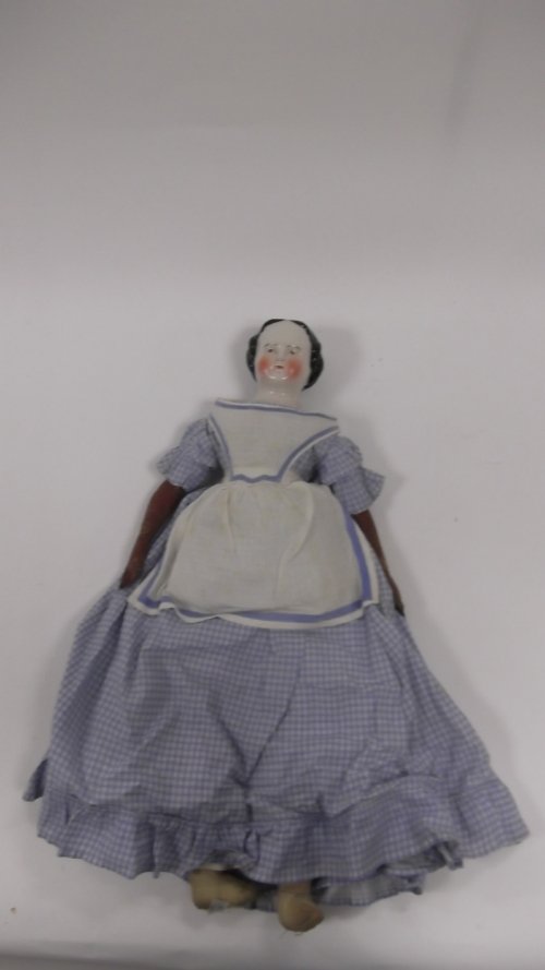 Appraisal: A porcelain headed doll with brown eyes and leather body