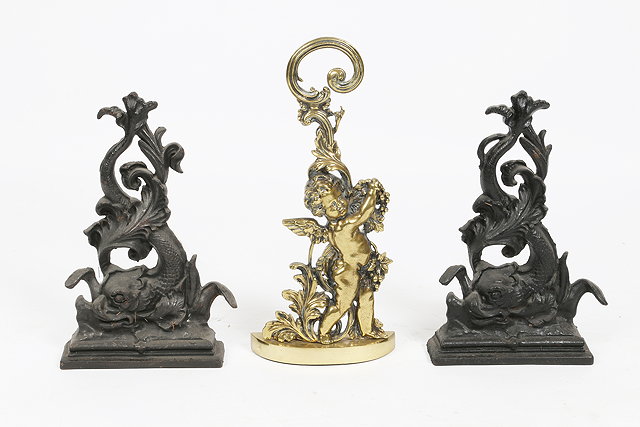 Appraisal: TWO OLD IRON DOOR STOPS in the form of scrolling