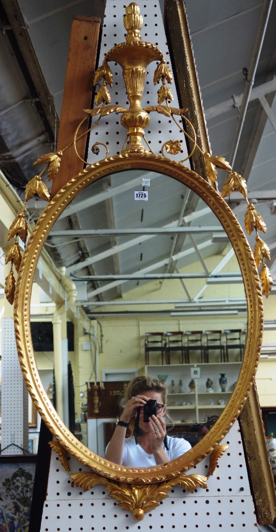 Appraisal: A th century gilt framed oval wall mirror of Adams