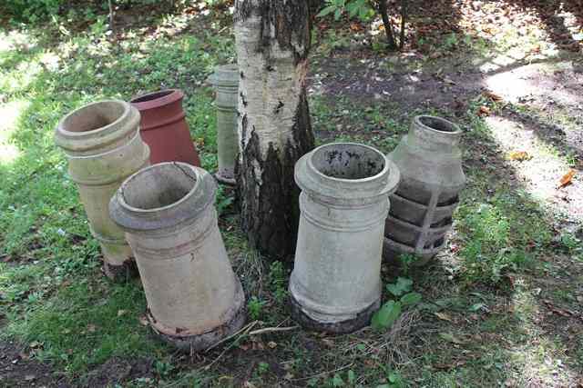 Appraisal: THREE BUFF TERRACOTTA CHIMNEY POTS high together with two further