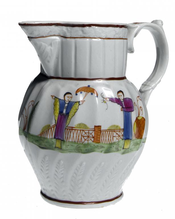 Appraisal: A STAFFORDSHIRE WRYTHEN FLUTED JUG moulded with stiff leaves and