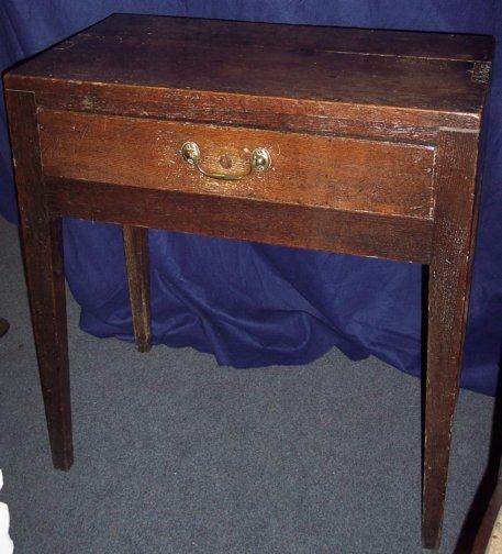 Appraisal: An oak side table fitted a drawer on taper legs