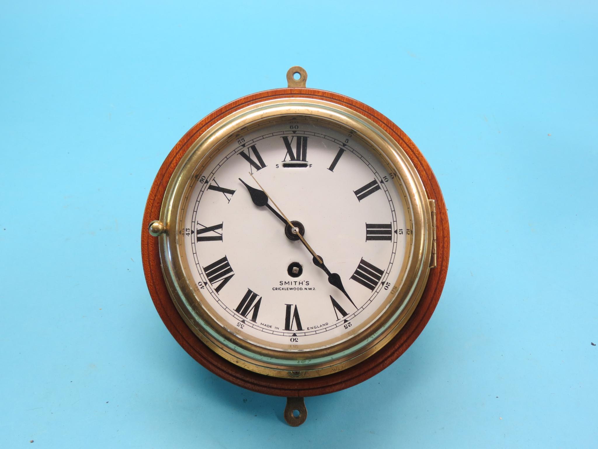 Appraisal: A Smith's ship's clock in enamel dial with centre-seconds spun