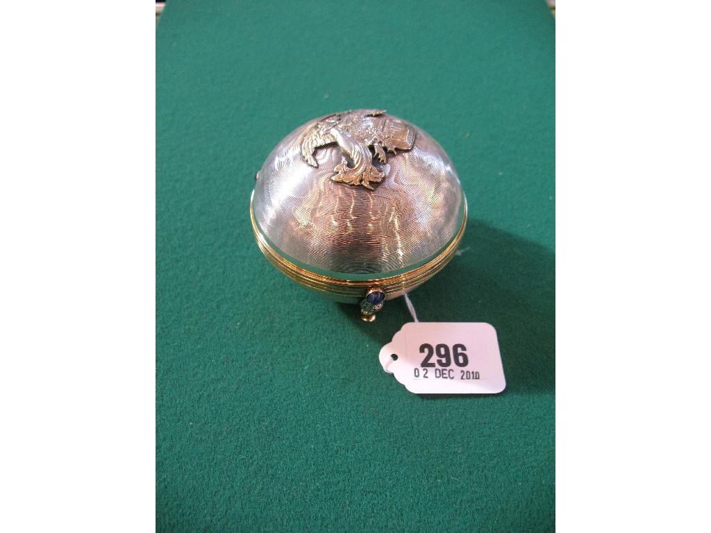 Appraisal: A SPHERICAL SILVER CHRISTMAS MUSIC BOX with engine turned decoration