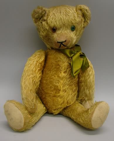 Appraisal: Gold mohair antique bear Fully jointed with swivel head Green