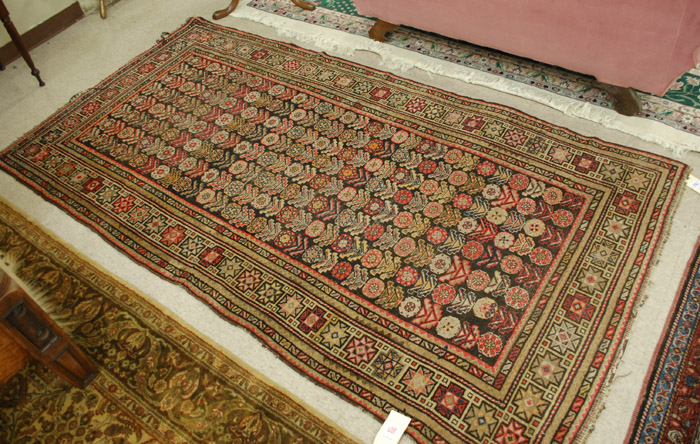 Appraisal: SEMI-ANTIQUE CAUCASIAN AREA RUG repeating columns of stylized flower heads