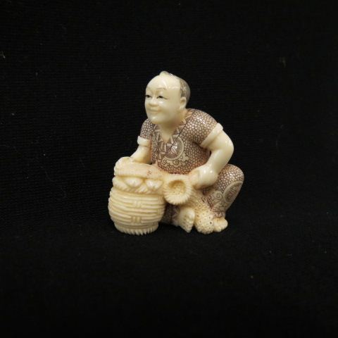 Appraisal: Carved Ivory Netsuke of a Manwith drum fine polychrome signed