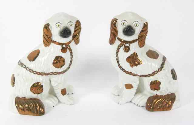 Appraisal: A pair of Staffordshire dogs each with copper lustre highlights