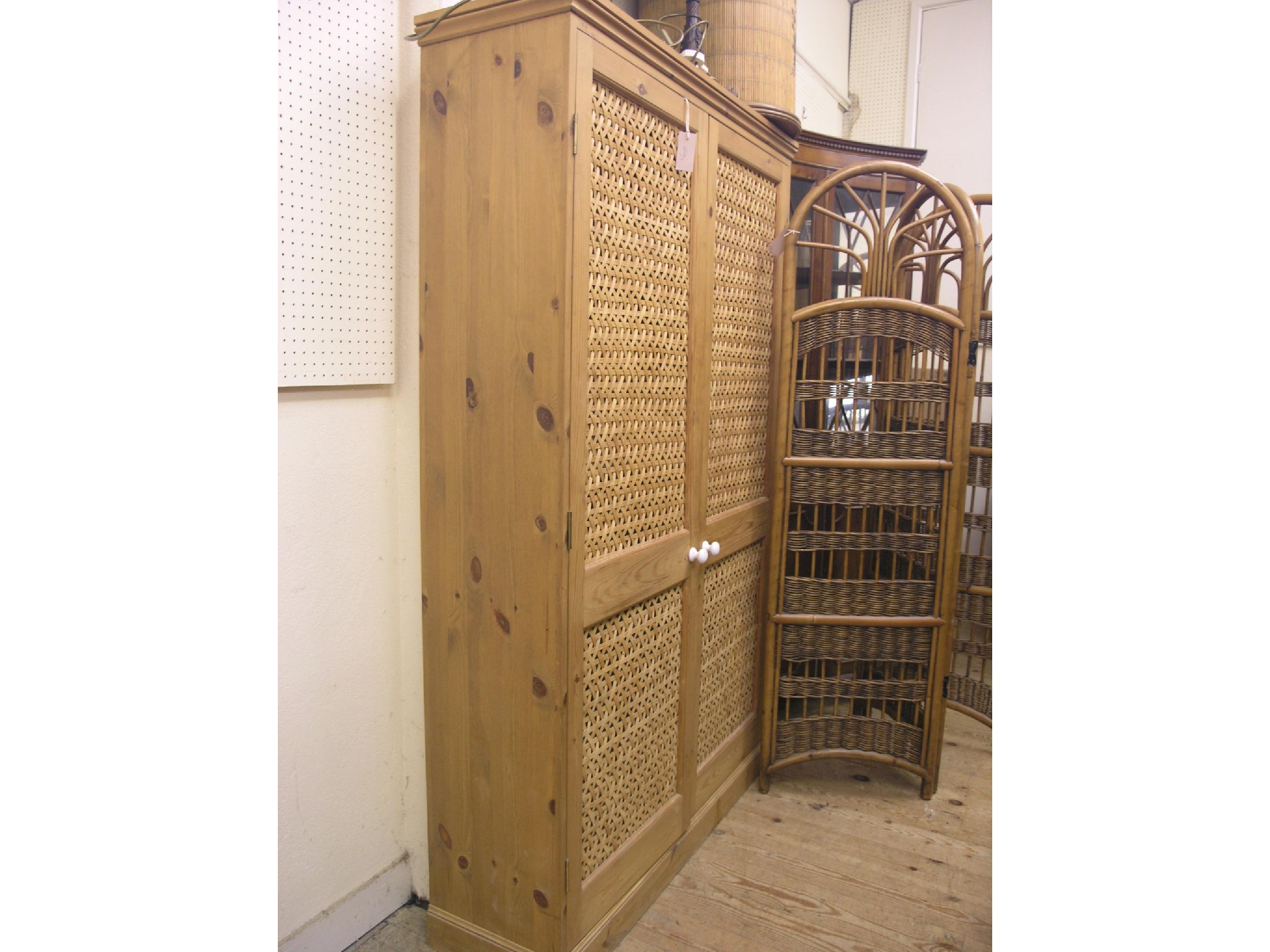 Appraisal: A waxed pine hall wardrobe enclosed by a pair of