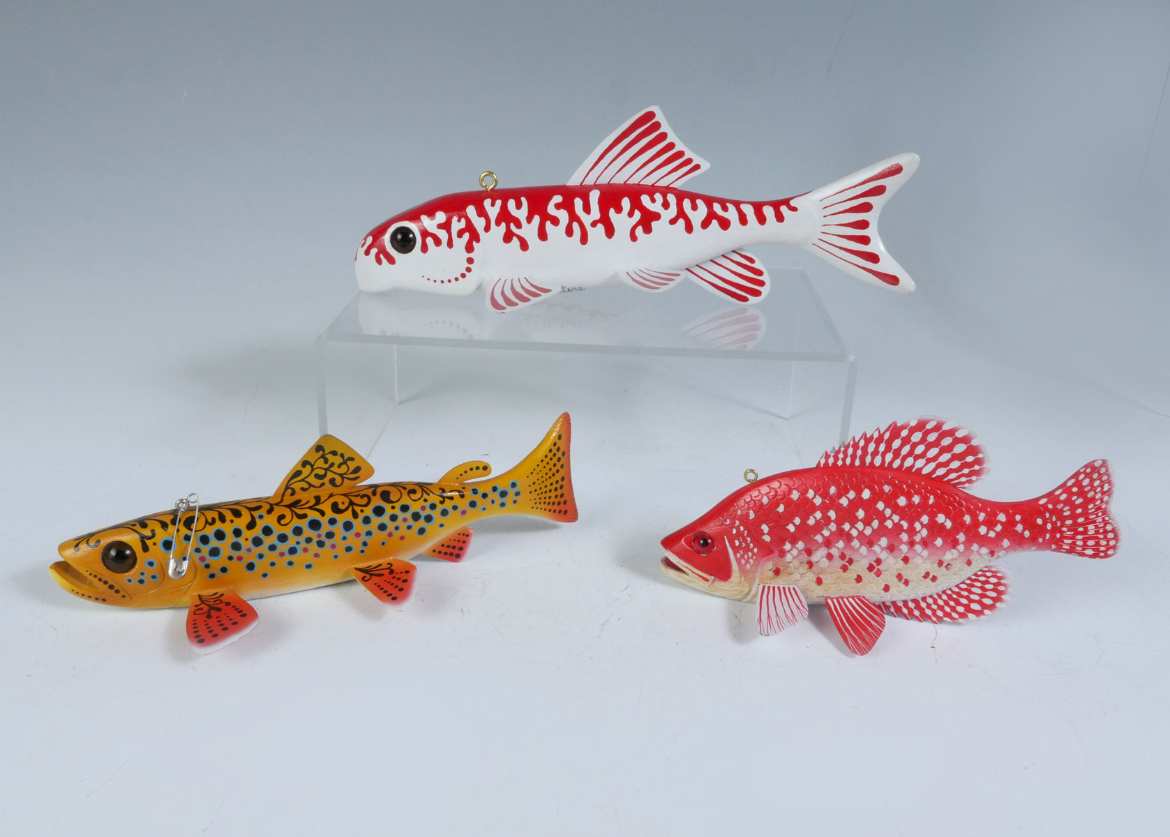 Appraisal: THREE JOHN PETERS PAINTED FISH DECOYS Yellow-Bodied Speckled Trout Type