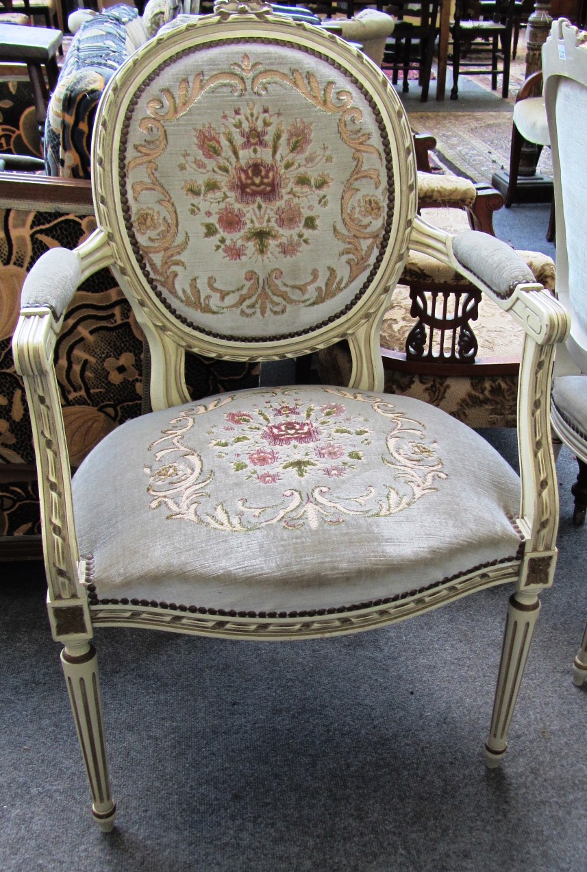 Appraisal: A Louis XVI style parcel gilt cream painted open armchair