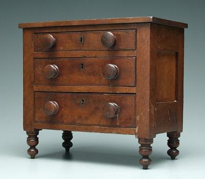 Appraisal: Miniature cherry chest paneled sides frame-and-panel back three dovetailed drawers