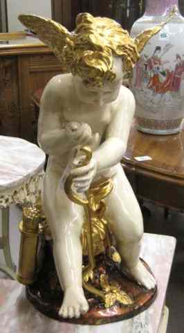 Appraisal: AN ENAMELED AND GILDED BRONZED FIGURAL SCULPTURE a winged cupid