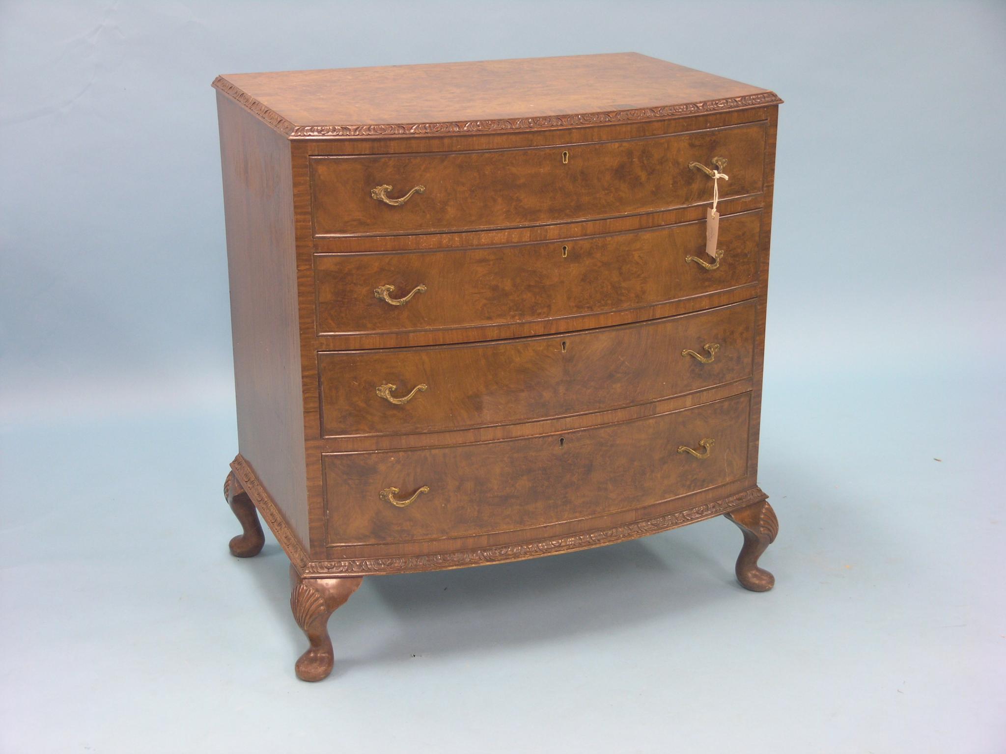 Appraisal: A reproduction burr walnut chest bow-fronted with four long drawers