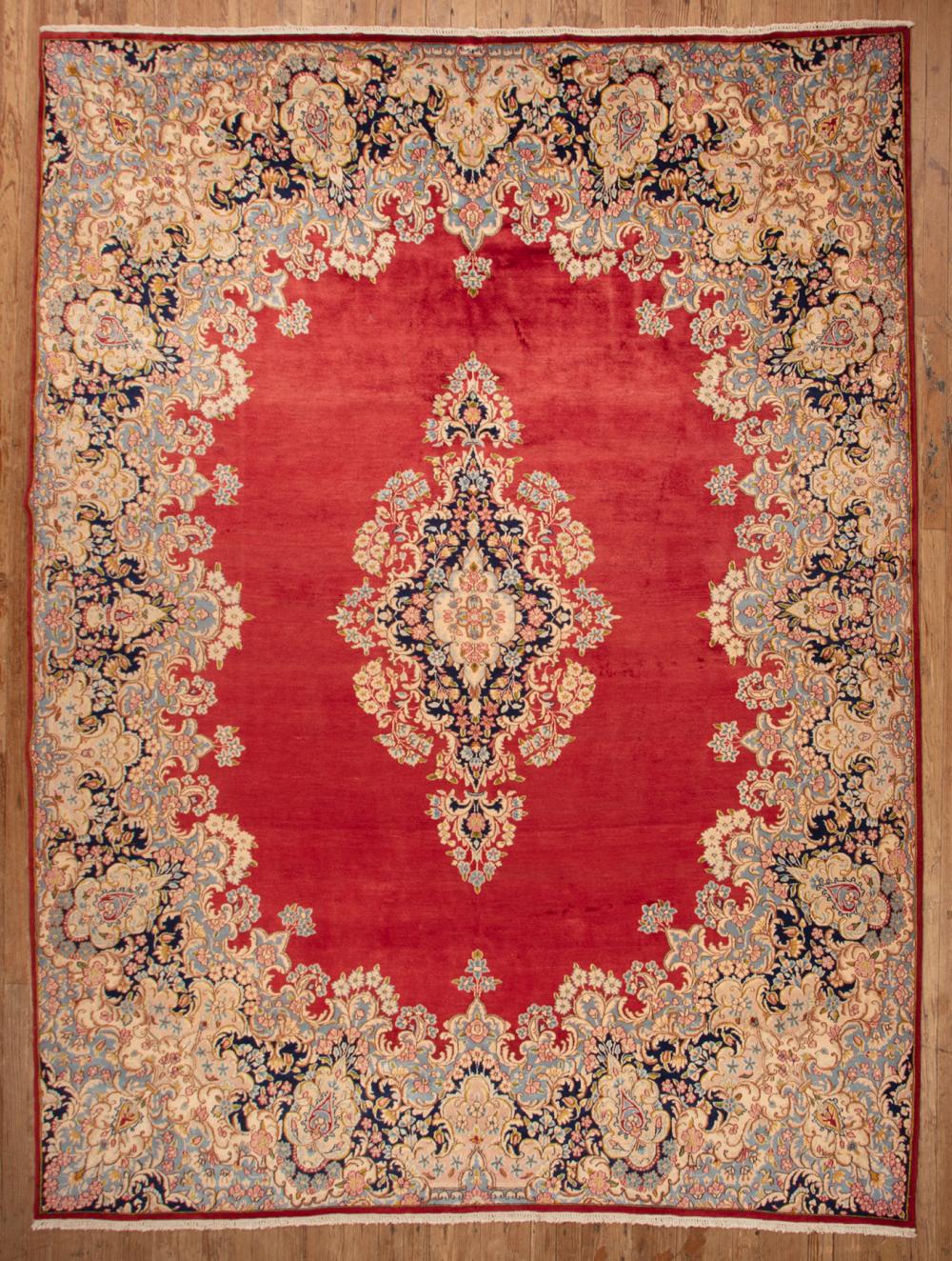 Appraisal: Persian Kerman Carpet red ground central medallion ft in x