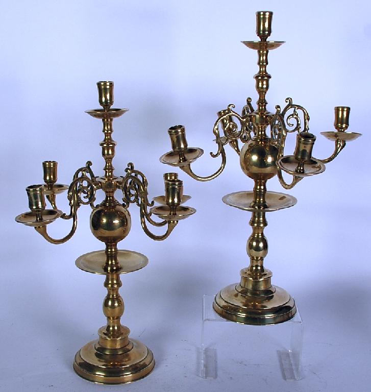 Appraisal: PAIR OF EASTERN BRASS FIVE LIGHT CANDELABRA with turned columns