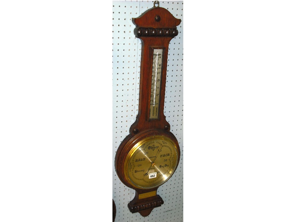 Appraisal: Oak aneroid barometer thermometer the silvered dial within a shaped