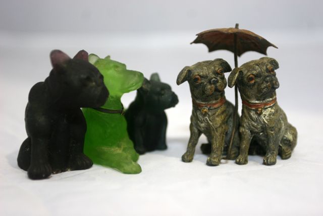 Appraisal: An Australian cold painted bronze of two Pugs sheltering beneath