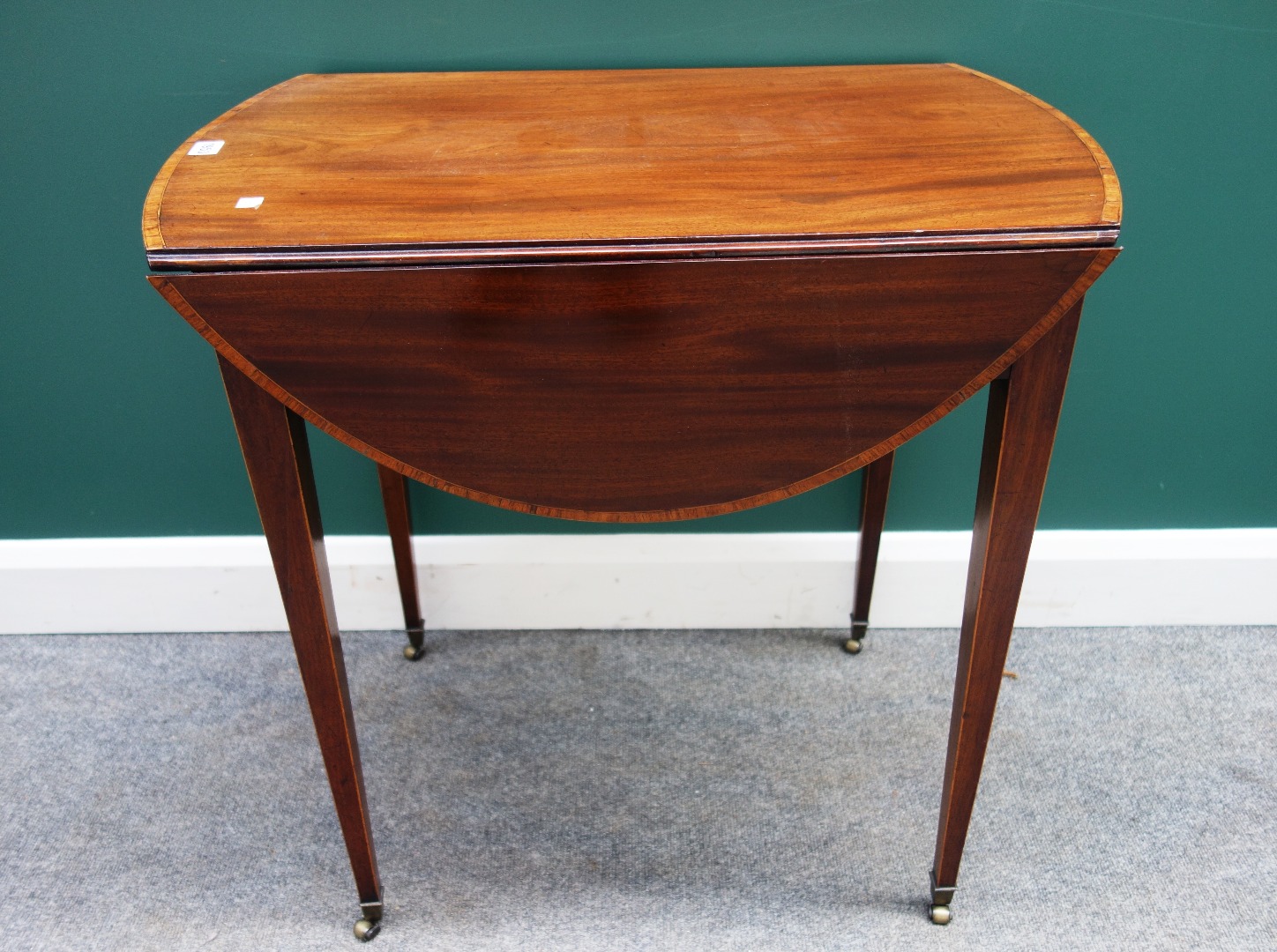 Appraisal: A George III tulipwood banded mahogany Pembroke table with rounded