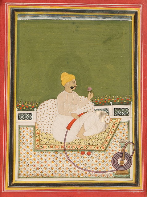 Appraisal: AN INDIAN MINIATURE painted with seated figure holding a flower