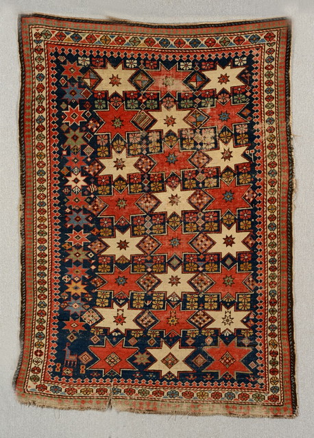 Appraisal: AN OLD SHIRVAN RUG decorated rows of stars and geometric