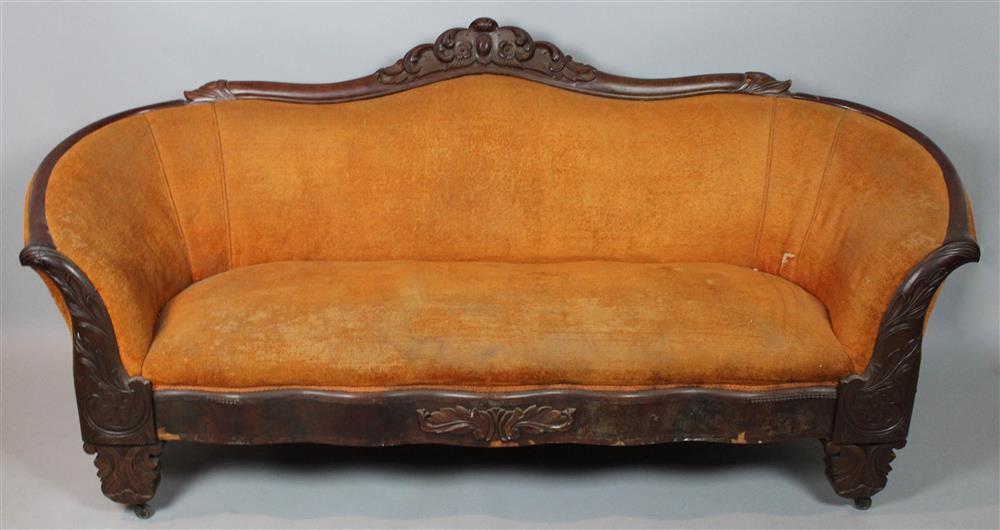 Appraisal: VICTORIAN MAHOGANY SOFA carved with scrolling foliage upholstered in orange