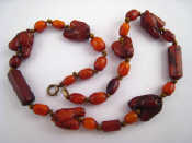 Appraisal: A necklace with amber beads carved as horses heads approx