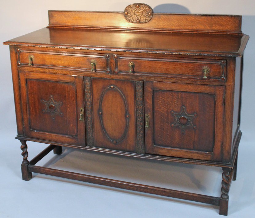 Appraisal: A mid- thC oak sideboard the carved beadwork back above