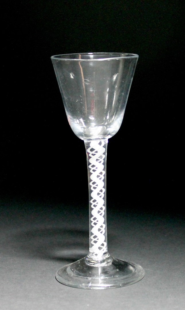 Appraisal: An opaque twist wine glass circa the rounded funnel bowl