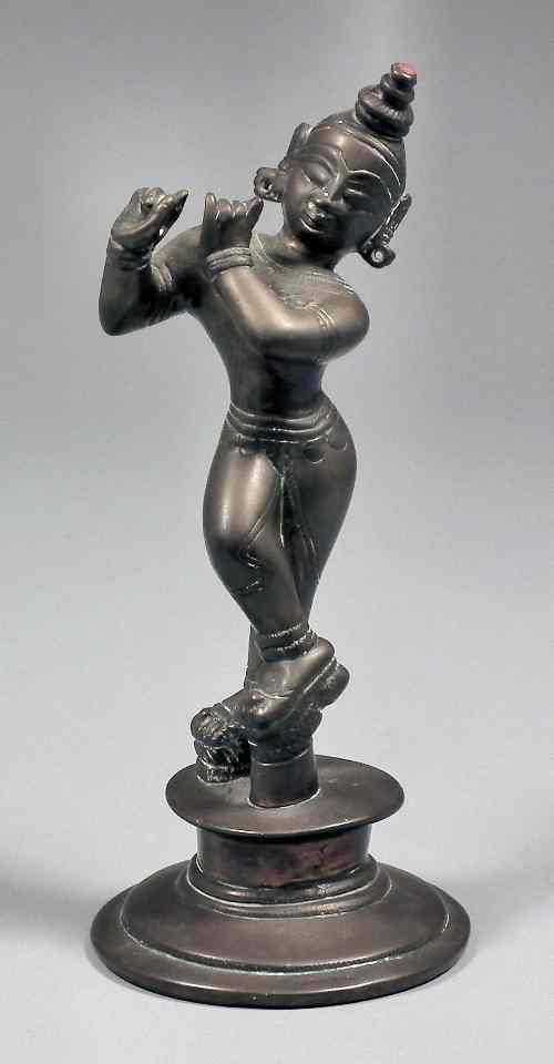 Appraisal: An Indian bronze standing figure playing a transverse flute flute