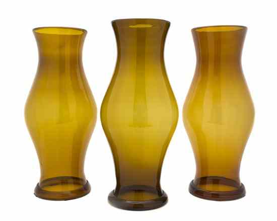 Appraisal: A Set of Three Amber Glass Hurricane Shades having a