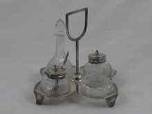 Appraisal: A four piece Victorian silver cruet on stand Birmingham with