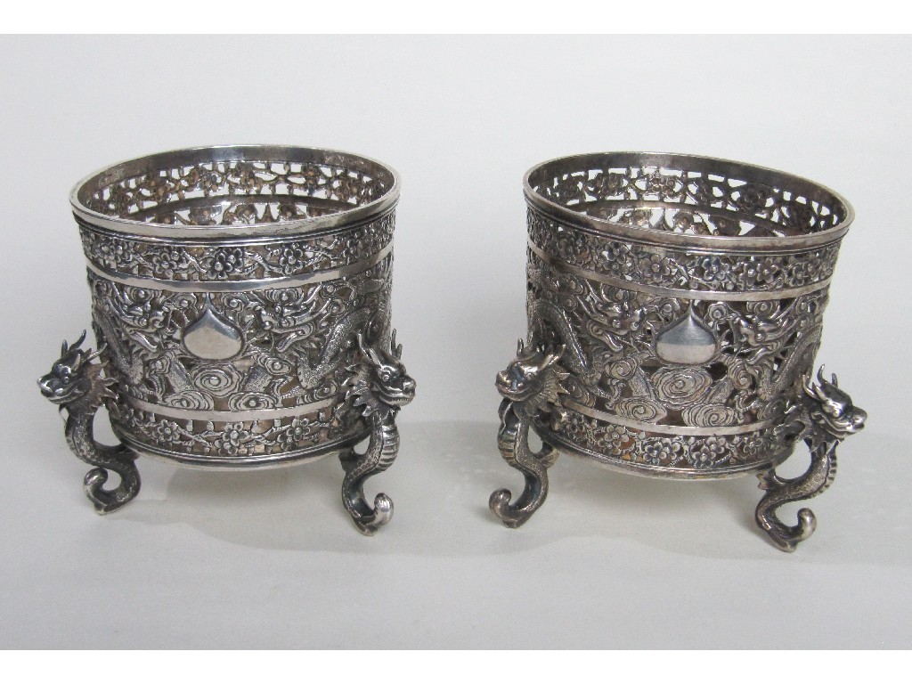 Appraisal: Pair of silver bottle stands with dragon decoration on three