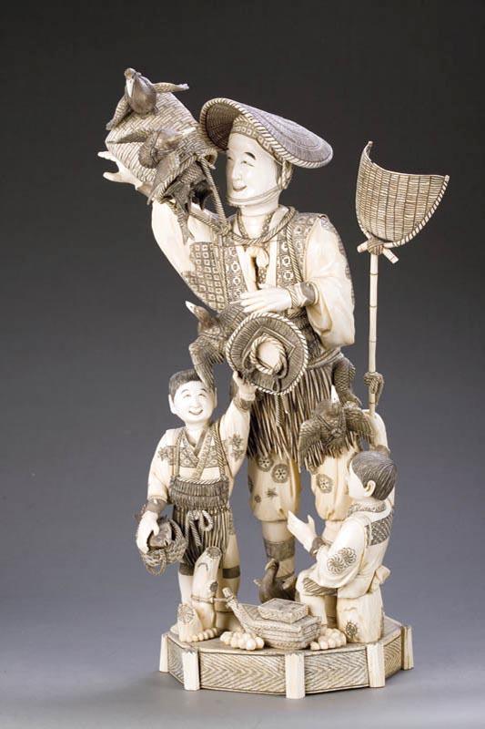 Appraisal: LARGE IVORY STATUE OF FISHERMAN Japan Figural group of a