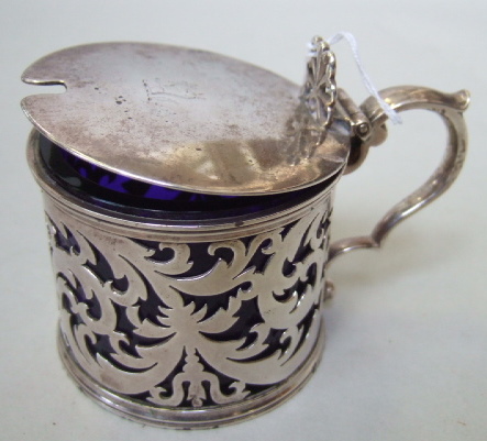 Appraisal: A Victorian silver hinge lidded mustard pot with scroll pierced