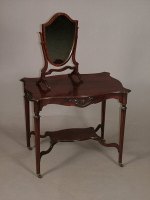 Appraisal: An Edwardian mahogany two tier centre table the shaped top