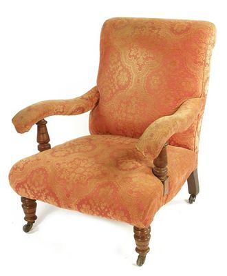 Appraisal: A late Victorian easy open armchair with turned walnut supports