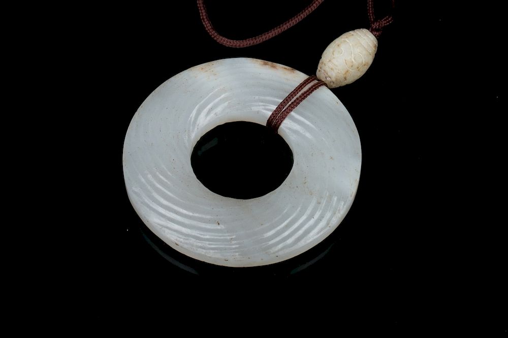 Appraisal: JADE DISC QING The jade disc carved with swirling lines