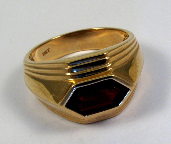 Appraisal: GARNET AND TEN KARAT GOLD RING set with a long