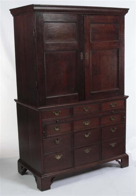 Appraisal: An th century provincial oak housekeeper's cupboard the projecting cornice