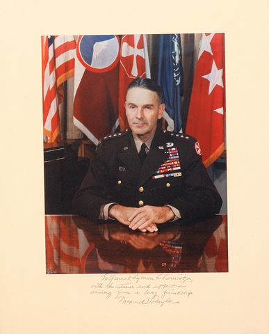 Appraisal: Photograph showing Taylor in uniform seated at desk with flags