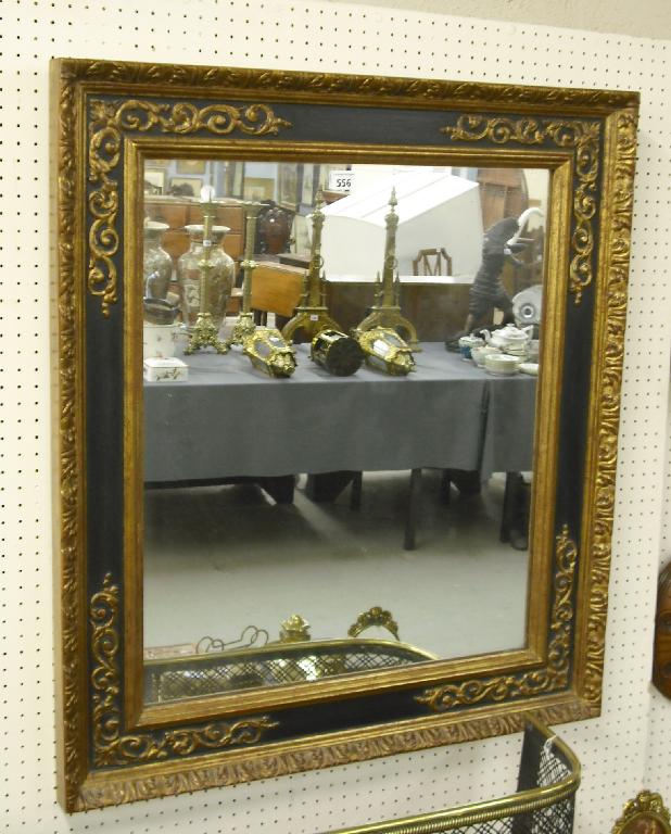 Appraisal: Decorative gilded and black painted wall mirror with moulded egg