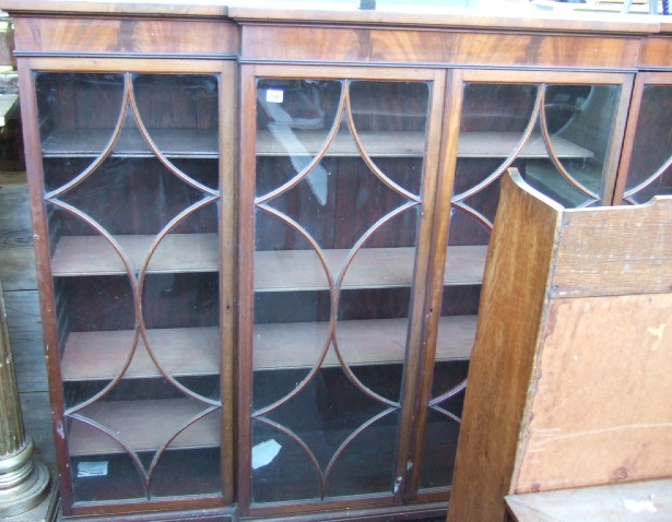 Appraisal: A mahogany breakfront floor standing bookcase the four astragal glazed